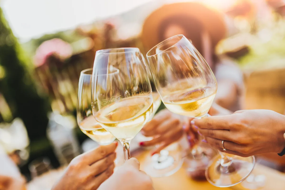 People clinking glasses with wine on the summer terrace of cafe or restaurant Beim ersten Steinheimer Weinfest am 12. und 13. September stehen Genuss, Musik und Geselligkeit im Mittelpunkt.