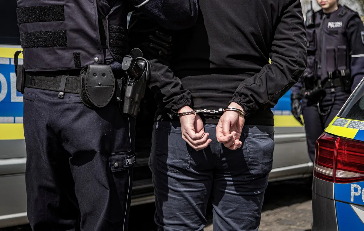 Mutmaßlicher Täter wird von Polizisten vorläufig festgenommen. Symbolbild